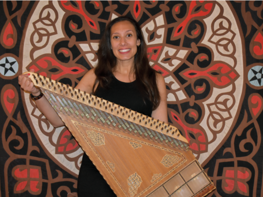 Dr. Eissa with her ancient Armenian folk instrument, the kanun. 