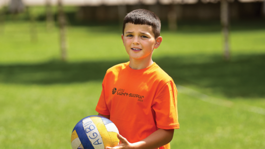 Nine-year old Gor playing volleyball at Camp Nairi.